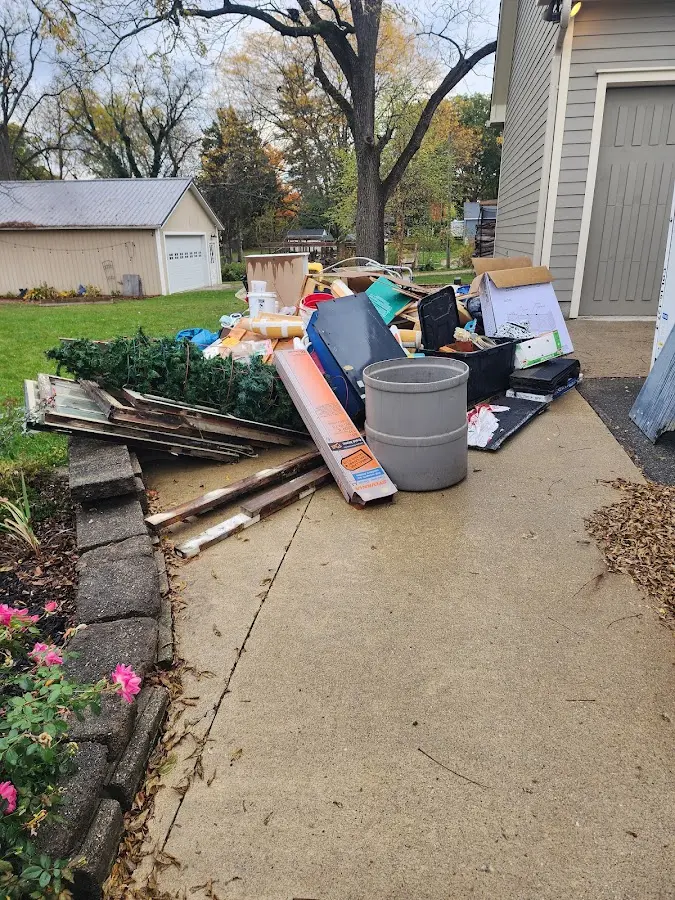 Dumpster being loaded with debris for Roofing Dumpster Rental in Melrose